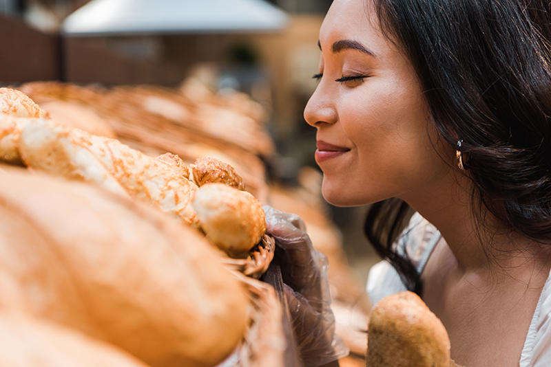 Woman Smelling Bread